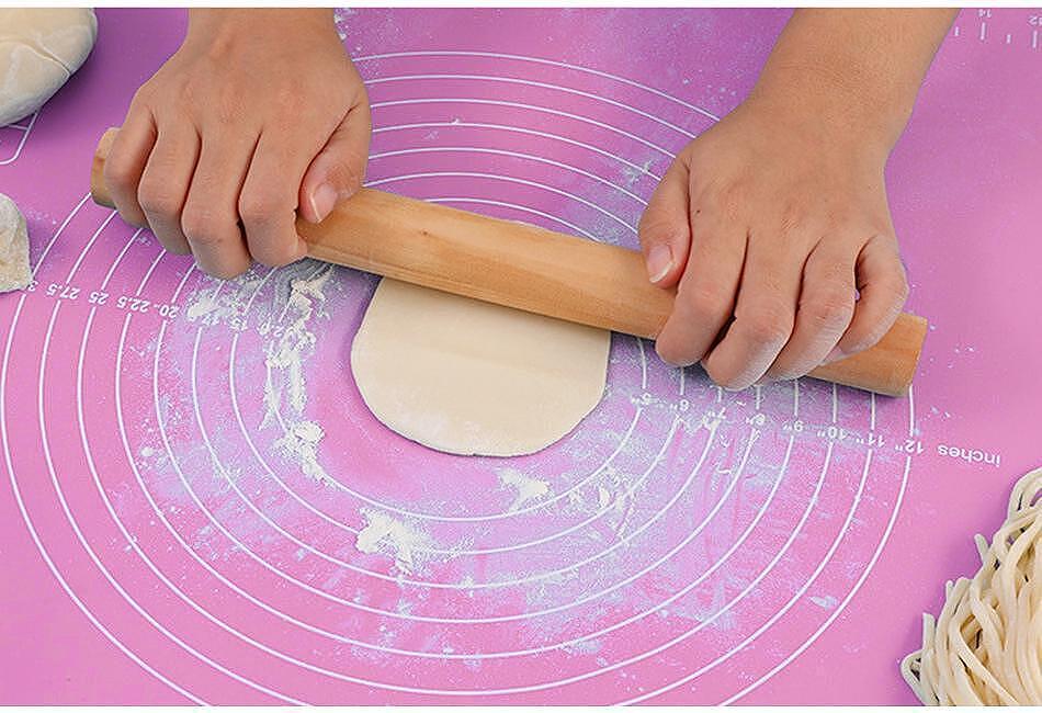 Ръце с точилка на силиконова подложка за месене, идеална за подготовка на тесто и сладкиши.